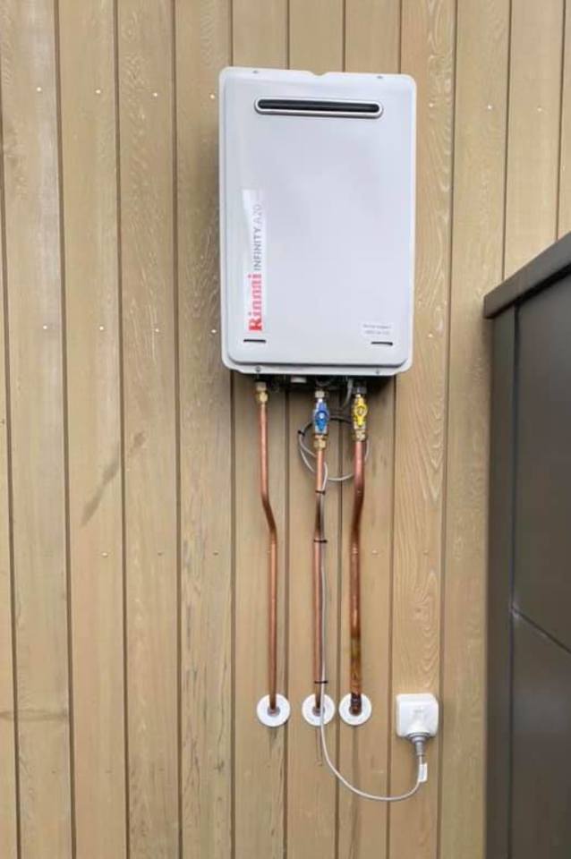 Rinnai INFINITY and copper pipe on house