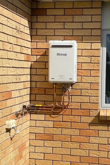 Rinnai hot water unit on brick house
